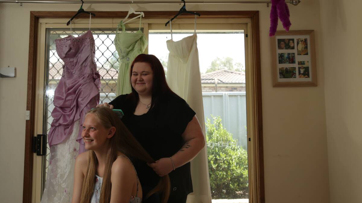 BALL: Karisma Robinson with her sister Skye looking over a selection of dresses in preparation for Karisma's formal, which Skye has organised for later this month. Picture: Simone De Peak