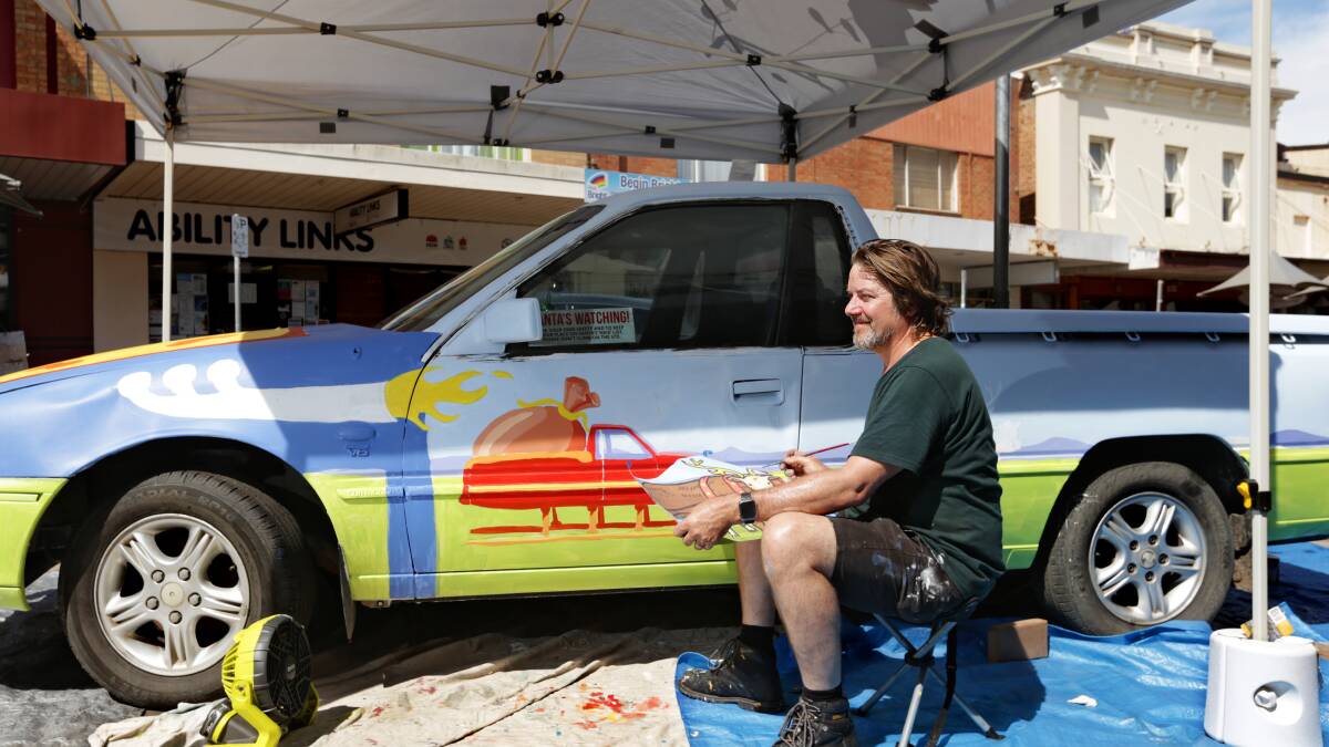 FESTIVE FEVER: Trevor Dickinson is painting a Christmas themed ute, which will be on display at The Levee for the next six weeks. Picture: Simone De Peak