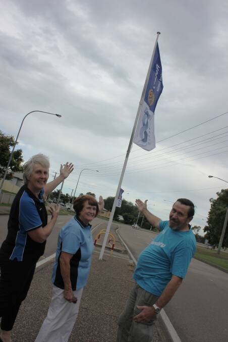 President of East Maitland Rotary Glenda Briggs, Area Governor Christine Walmsley and Rotarian Keith Bush show off the Rotary banners to mark 100 years. Picture: Michelle Mexon