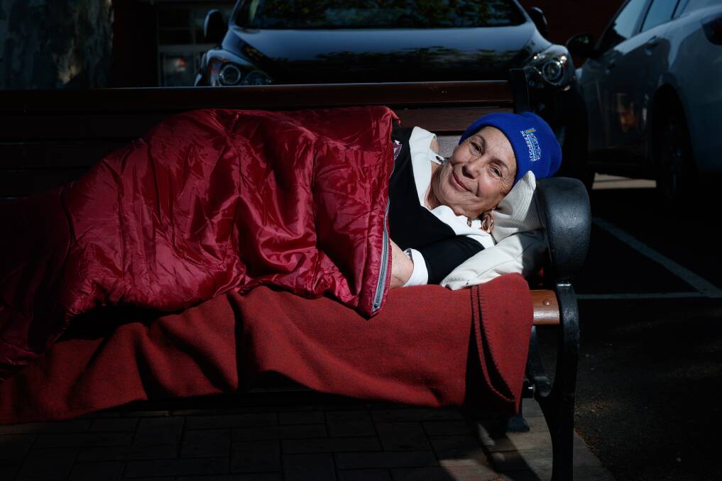 COSY: Maitland mayor Loretta Baker, laying in a mock bed on a park bench on the river walk. Picture: Max Mason-Hubers 