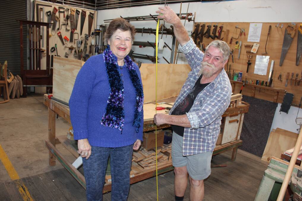 SIZING UP: Dungog Menshed member Steve Jones ensures he has the right measurements for Helen Proud's coffin which her family will decorate. Helen will meet the legal requirements of the interior makeup of the coffin.
