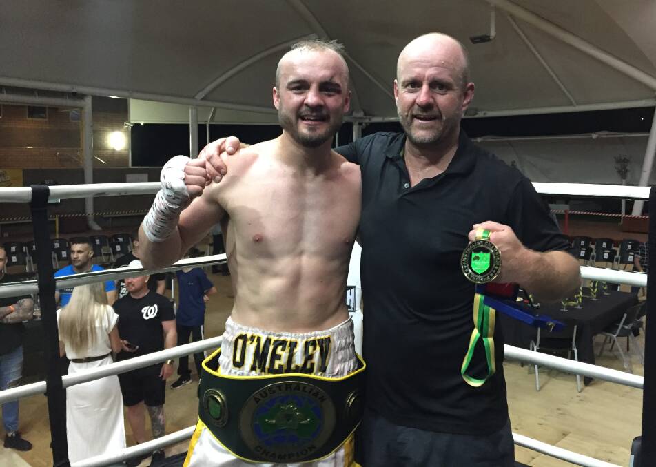 CHAMPION: Cessnock boxer Troy O'Meley and his father and trainer Tony O'Meley after claiming the Australian Super Welterweight Championship in March. Picture: Michael Hartshorn