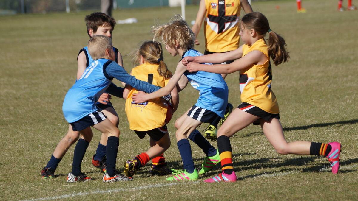 SUPPORT: Boys and girls, and just as importantly their parents, are converting to playing Aussie Rules.
