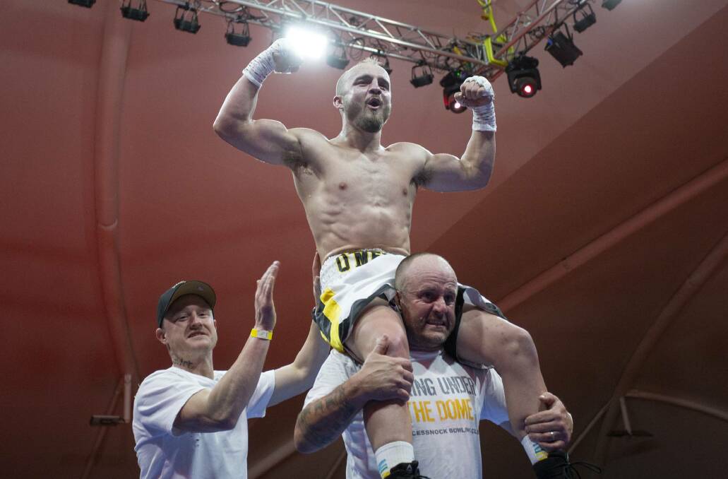 FAMILY AFFAIR: Troy O'Meley is held up by his father Tony and brother Kane after beating Indian fighter Sagar Narwat to claim the Australian title. Picture: Ness Sapsford, Total Fitness