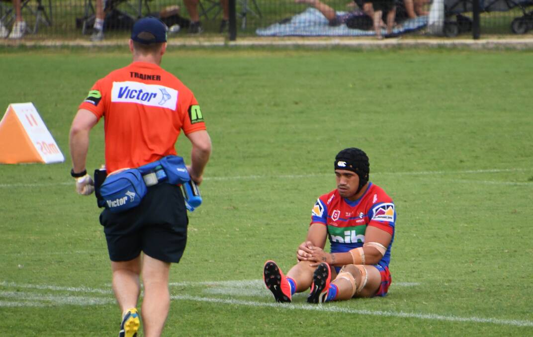 Injury: Sione Mata'utia clutches at his knee as a trainer runs out to check his injury. Picture: Michael Hartshorn