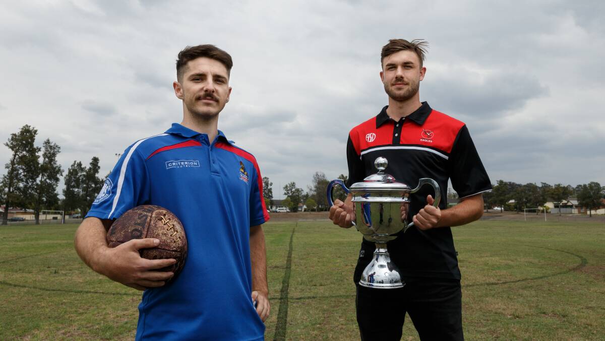 GAME ON: Dale Lantry from Kurri Kurri Football Club and Ayden Brice from Edgeworth Eagles with the Heritage Cup. Picture: Max Mason-Hubers