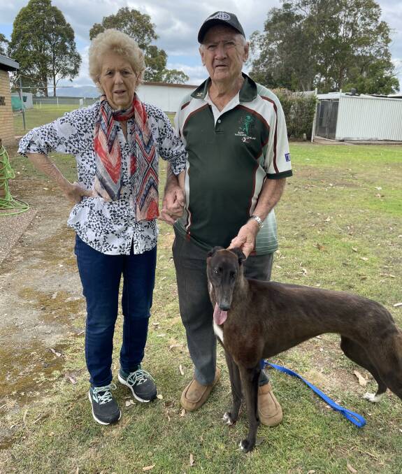 The man with the magic hands John Munro with his wife Barbara and Jim York's young pup Marvel Munro at his Mulbring property this week. Picture by Jim York