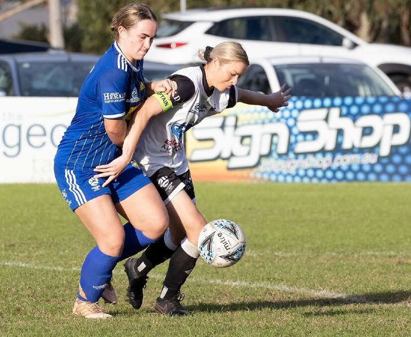STRONG: Maitland skipper Sophie Stapleford holds off a Newcastle Olympic opponent. Picture: Graham Sports and Nature Photography