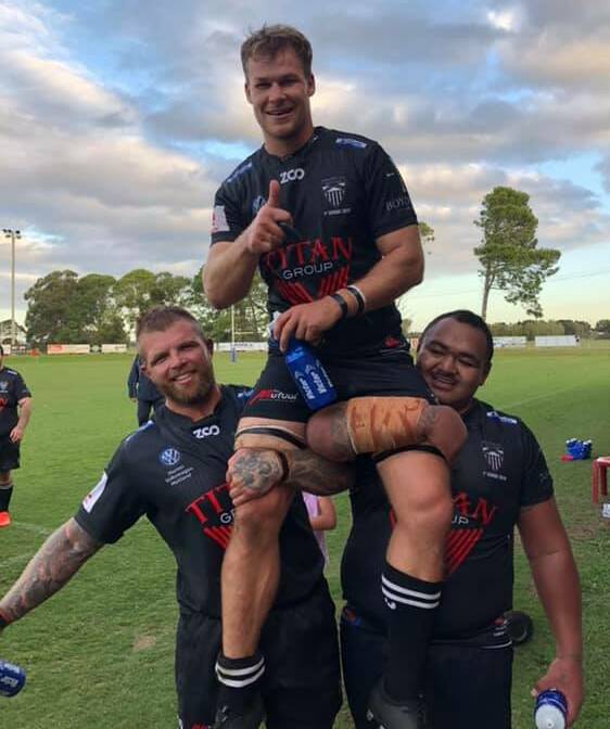 150 GAMES STRONG: Nick Davidson and Willie Soe chair James Johnston from the game after his 150th game for the Blacks. Picture: Supplied