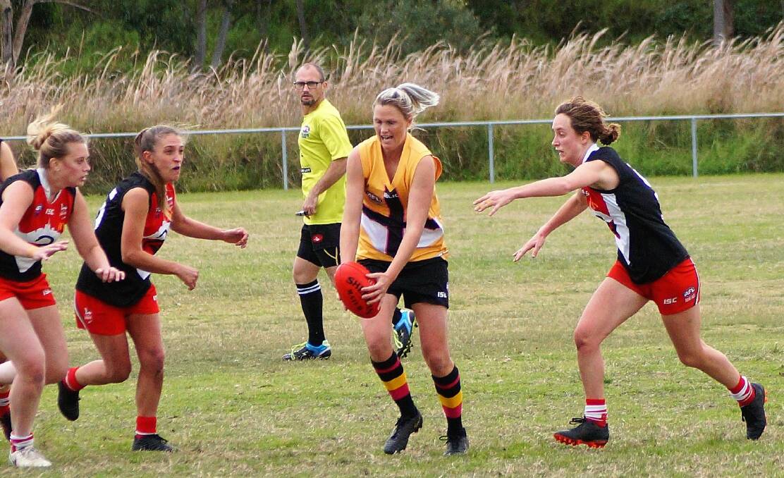 STRONG: Maitland's Anna Fraser beats three opponents to send the ball forward for the Saints. Picture: Rick Merrick