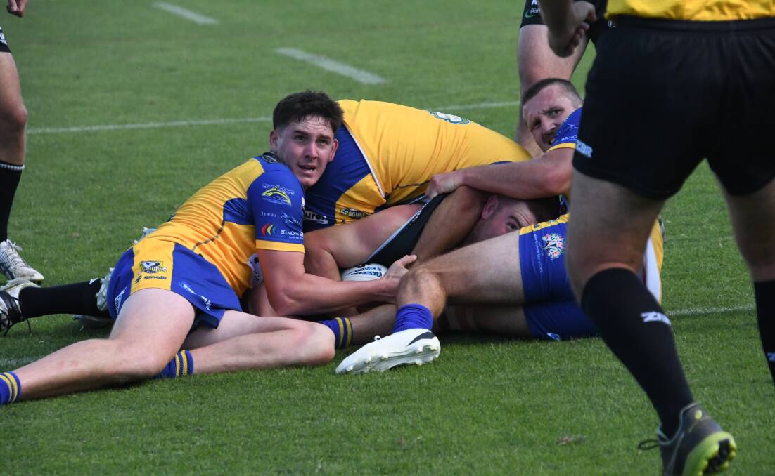 All eyes are drawn to the referee for his verdict on whether Maitland prop Jayden Butterfield got the ball down for a try. Picture by Michael Hartshorn