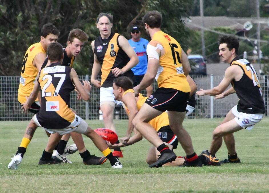 TENACIOUS: Maitland Saints midfielder Dustin Spriggs clears the ball from the bottom of a pack against Gosford Tigers. Picture: Michael Hartshorn