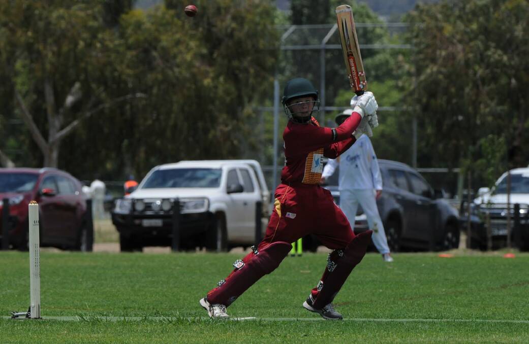 Sam Holz strokes the ball square on the way to making 140 for Maitland Maroon under-13s. Picture: Grant Power