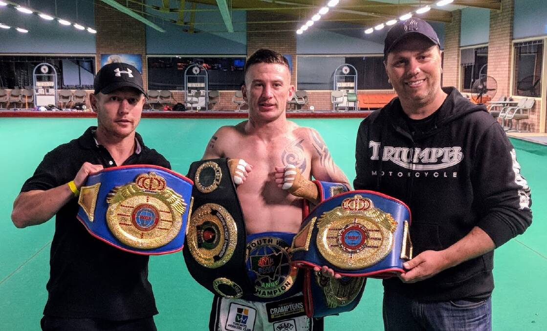 CHAMPION: Blake Minto with corner man Daniel Ford and trainer Ben Crampton after collecting his fifth professional title.