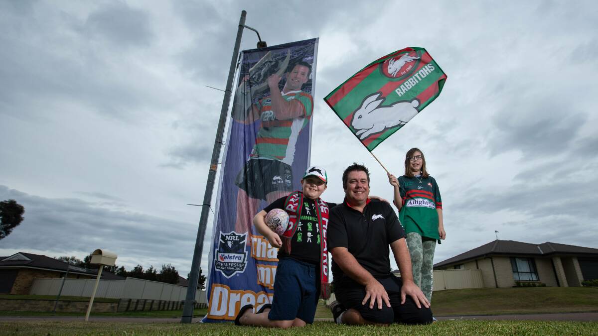 Glory, Glory to South Sydney: Rabbitohs tragic Tim Clarke displays his Souths colours with children Alex and Megan. Picture: Marina Neil