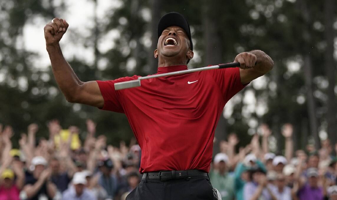 JUBLIANT: Tiger Woods celebrates winning his first major in eight years.