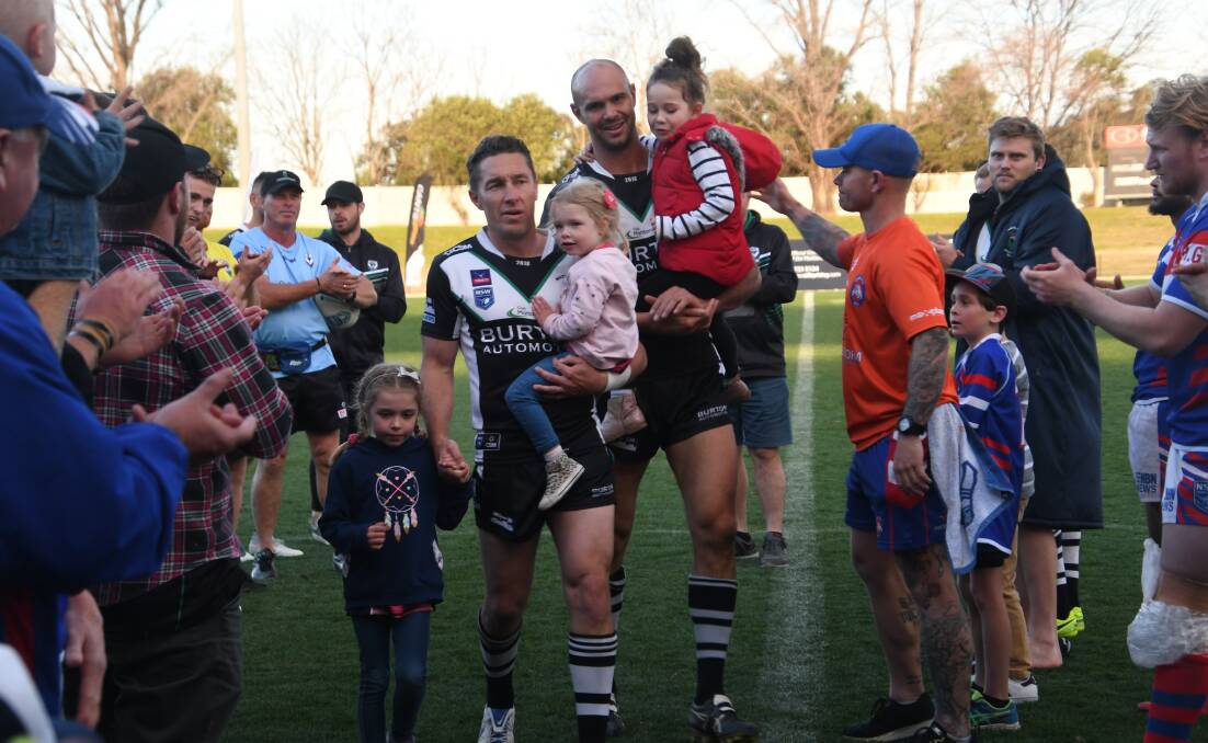 THANKS FOR THE MEMORIES: Luke Dorn and Dan Tilse are applauded from the ground after calling an end to their playing careers. Picture: Michael Hartshorn