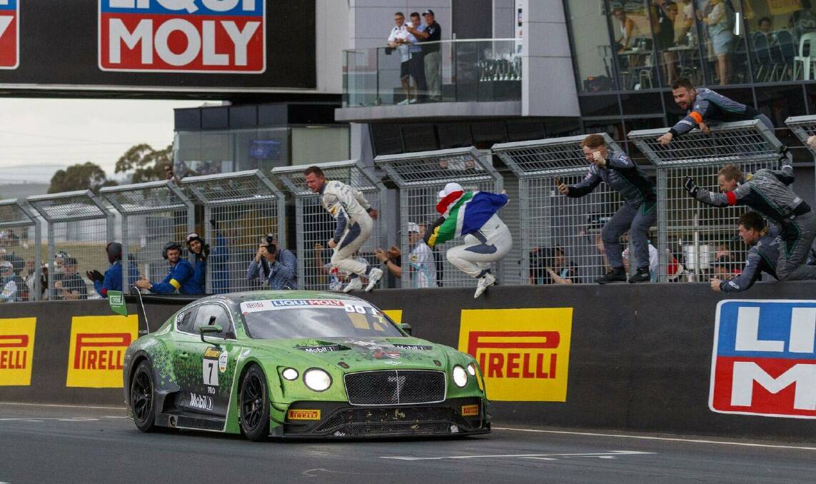 Excited pit crew celebrate as the No.7 Bentley takes out the Bathurst 12-Hour.