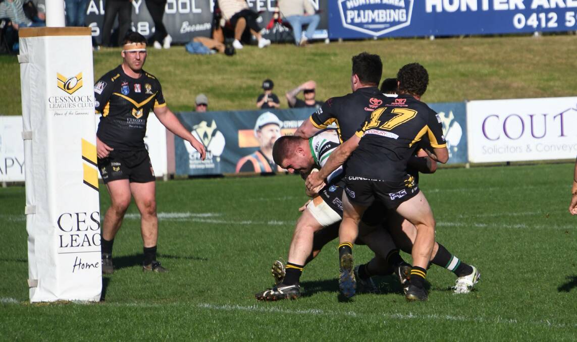 OPENING TRY: Maitland prop Jayden Butterfield smashes through three Cessnock defenders to score the opening try of the match. Picture: Michael Hartshorn