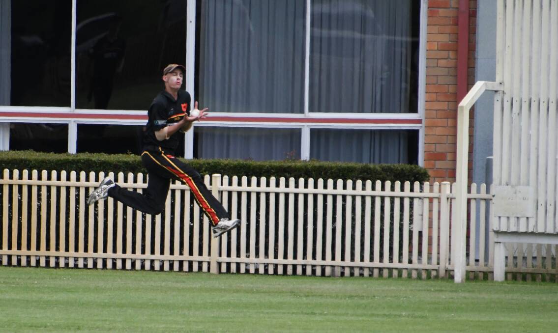 SIX OR OUT: Northern Suburbs all-rounder Cal Gabriel leaps, after running full pace around to boundary, to catch Daniel Flynn out just short of a six. Picture: Michael Hartshorn
