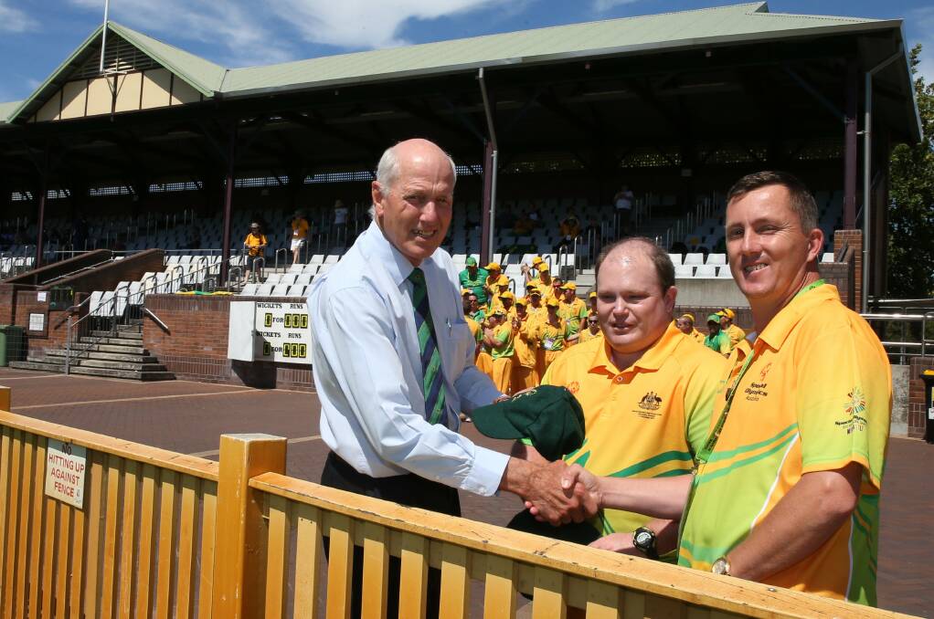 LEGEND: Former Test opener Rick McCosker presents presents the Australian Special Olympics cricket team captains Ben Haack and Jason Nelson with their caps. Picture Dean Osland