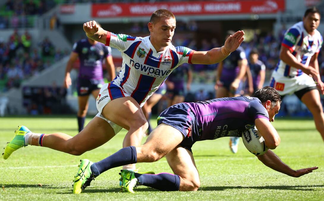 Cooper Cronk of the Storm scores a try against the Newcastle Knights at AAMI Park on Saturday.