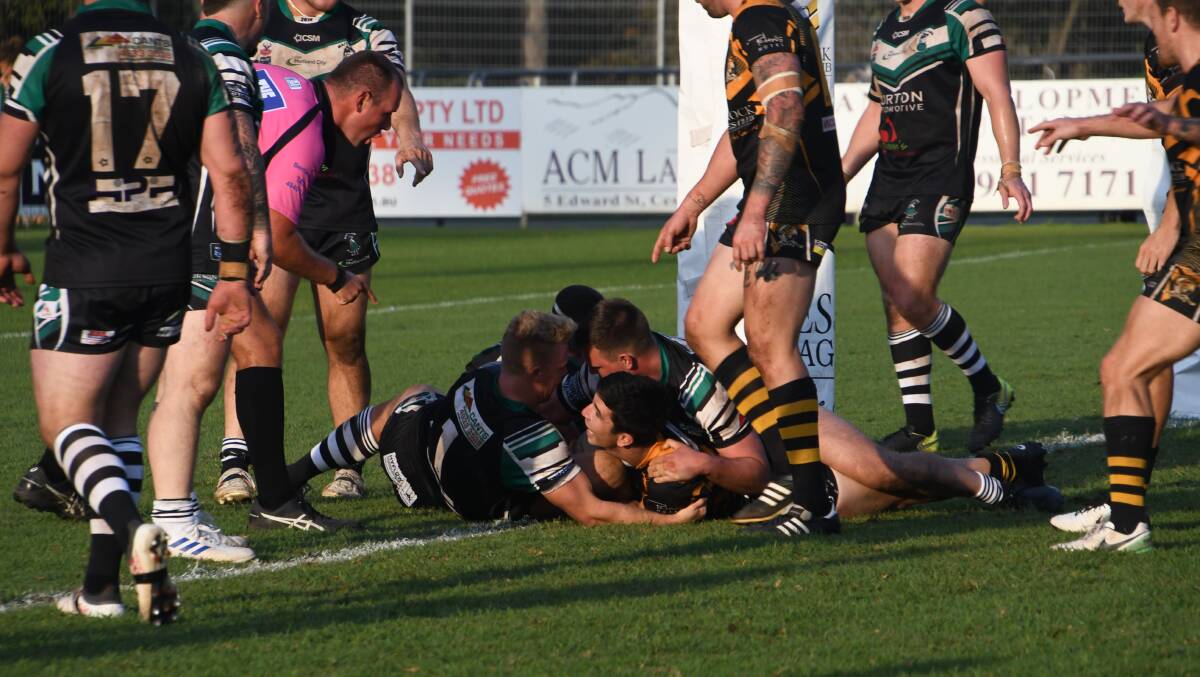 HELD OUT: Goannas dummy-half Nick Lawrence is denied a last-minute try by the Pickers defence. Picture: Michael Hartshorn