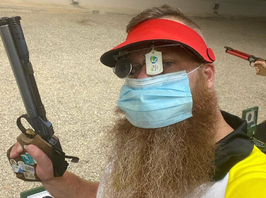 MASKED GUNMAN: Dan Repacholi wears a mask on the shooting range at the Australian Olympic Shooting teams training headquarters in Queensland.