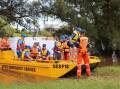 Griffins express: SES volunteers help members of the Eastern Suburbs fifth grade team ashore at Morpeth after ferrying them from Hinton.