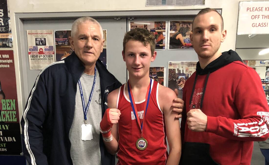 WINNING TEAM: Jesse Reid with his boxing coach Greg Tindall (left) and conditioning coach John Tindall (right).