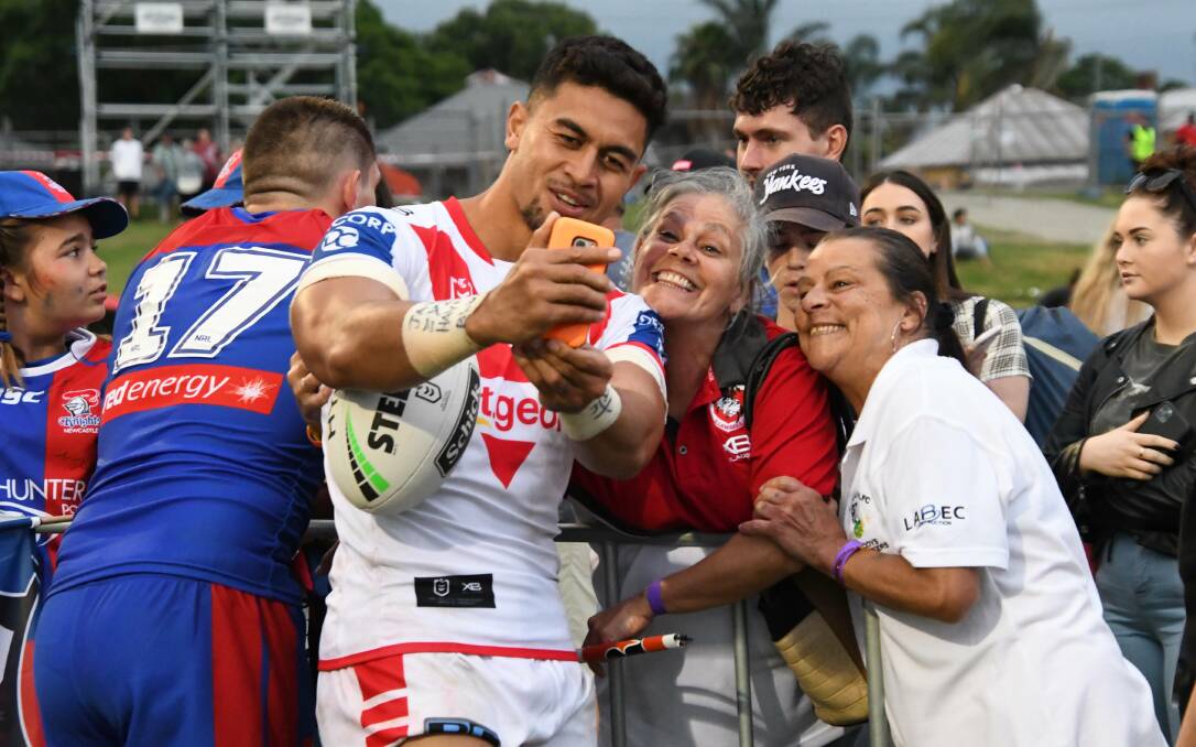 PHOTO WITH ROYALTY: Dragons player Tim Lafai poses with Maitland rugby league royalty Robyn and Joanne Wright daughters of the late great Merv.