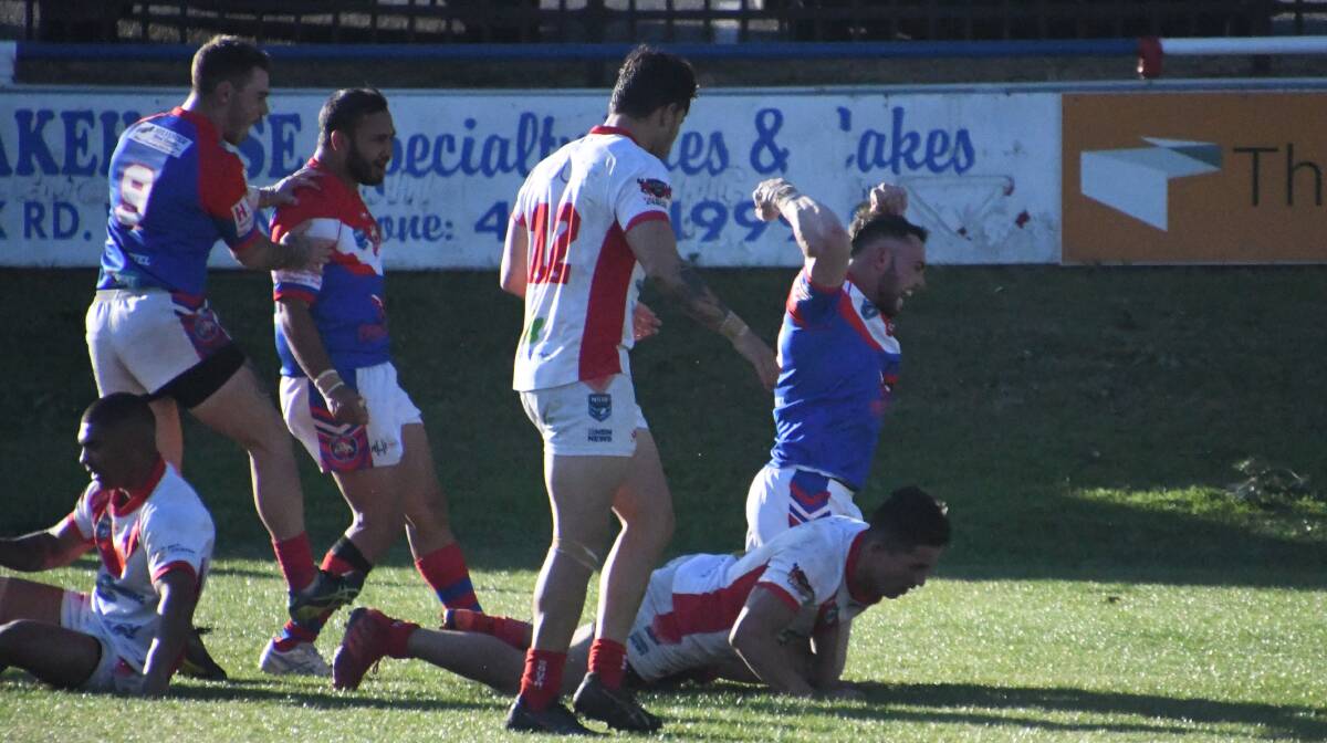 CELEBRATION: Tom McKenzie and Ngangarra Barker race to congratulate Jayden Young after he crosses for a try two minutes after the break. Picture: Michael Hartshorn