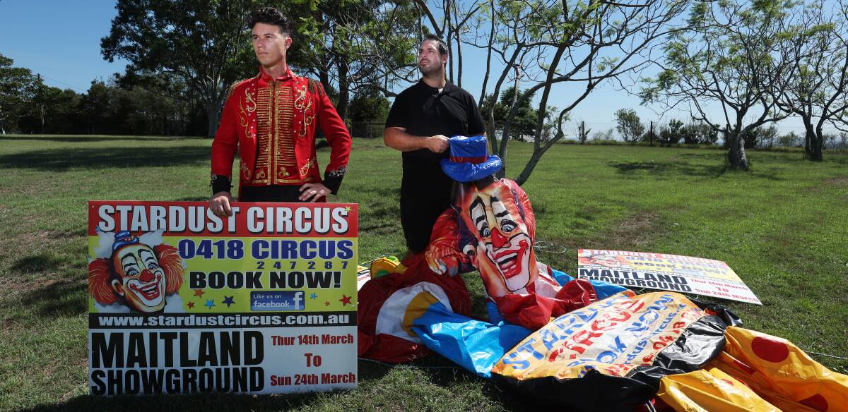 Stardust Circus' Jake Larkin and Shannon Dennis with promotional signage at a property on Cessnock Road, Gillieston Heights. Picture by Simone De Peak