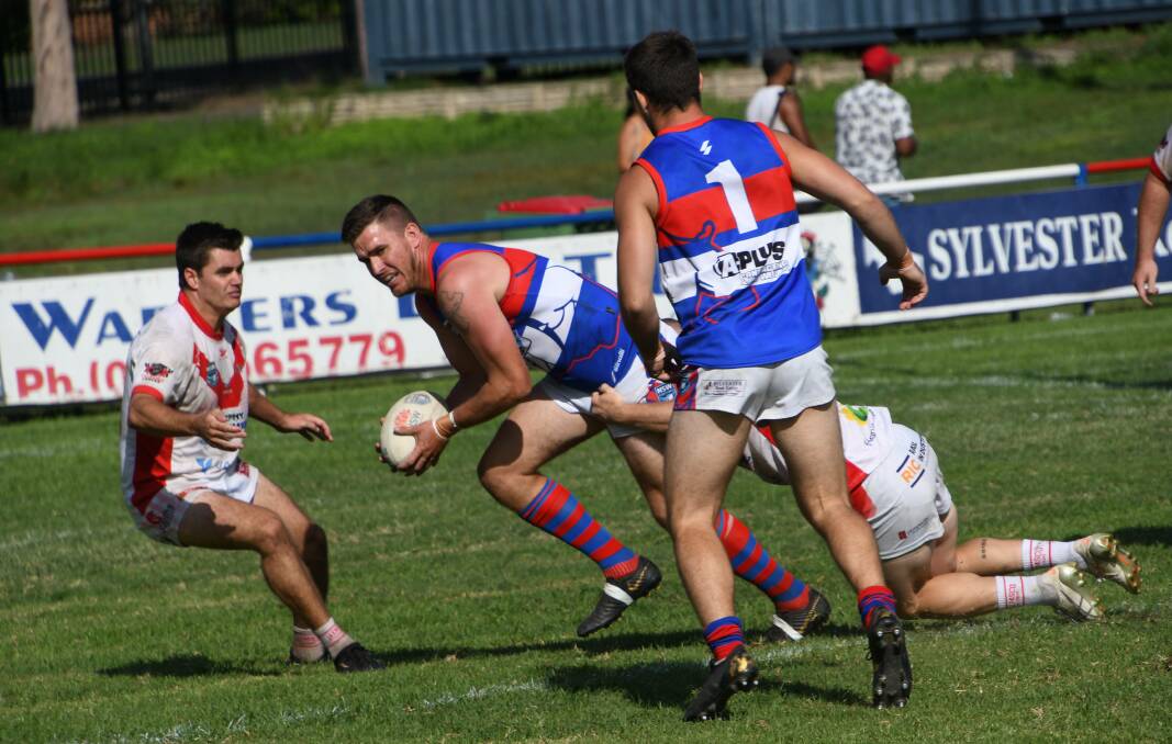 A super-fit Brady Hammond breaks the tackle of a South Newcastle defender. Picture: Michael Hartshorn
