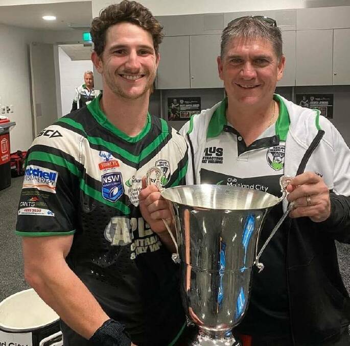 Frank Lawler holds the 2022 Newcastle RL premiership cup with son Matt Soper-Lawler. Picture supplied.