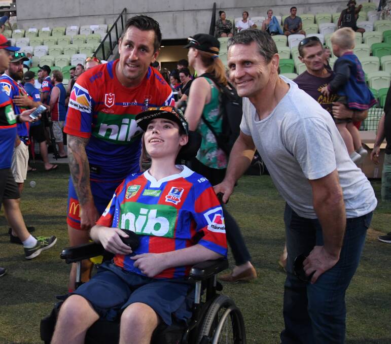 MAGICAL MOMENT: Mitchell and Wayne Pearce get a photo with young Knights fan Kayden Benbow. Picture: Michael Hartshorn