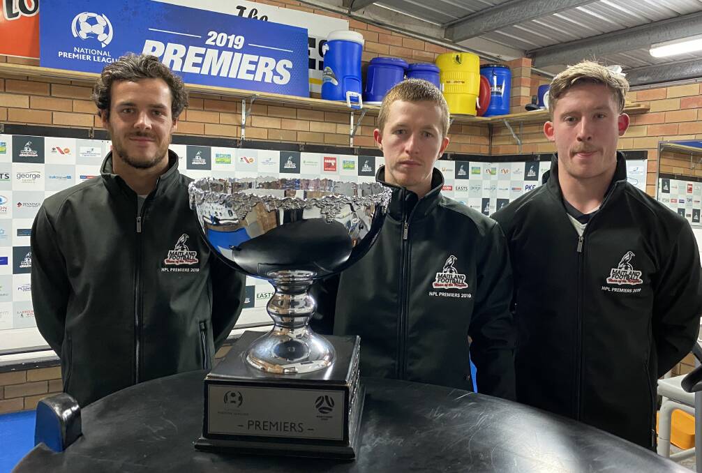 TITLE DEFENCE: Maitland Magies trio Tom Davies, Braedyn Crowley and Jimmy Thompson with the premiers trophy this week..