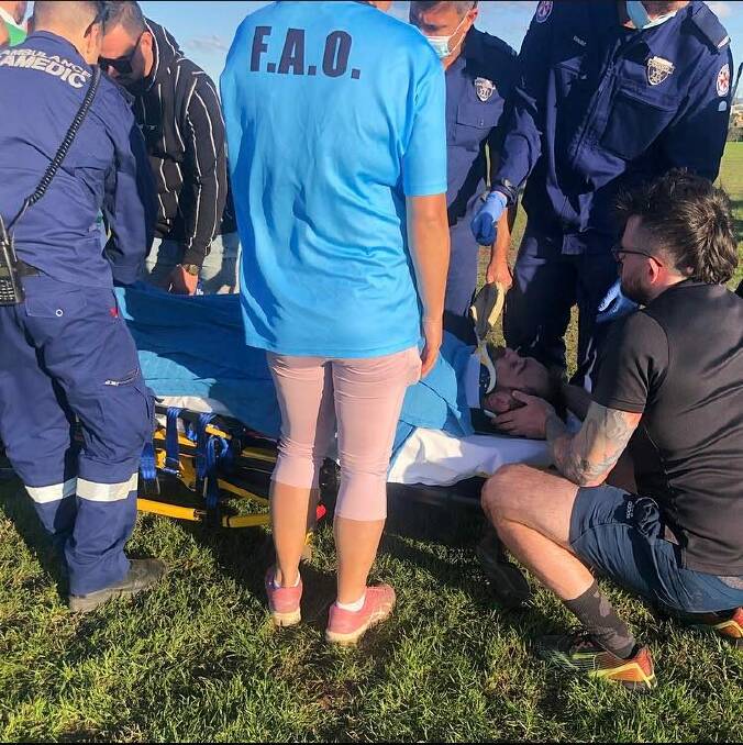 Paramedics and medical staff caring for injured East Maitland footballer Joe Andrews on Sunday.