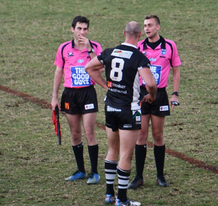 The referees talk to Maitland's Dane Tilse before sending him off for fighting at the end of the game against Cessnock.