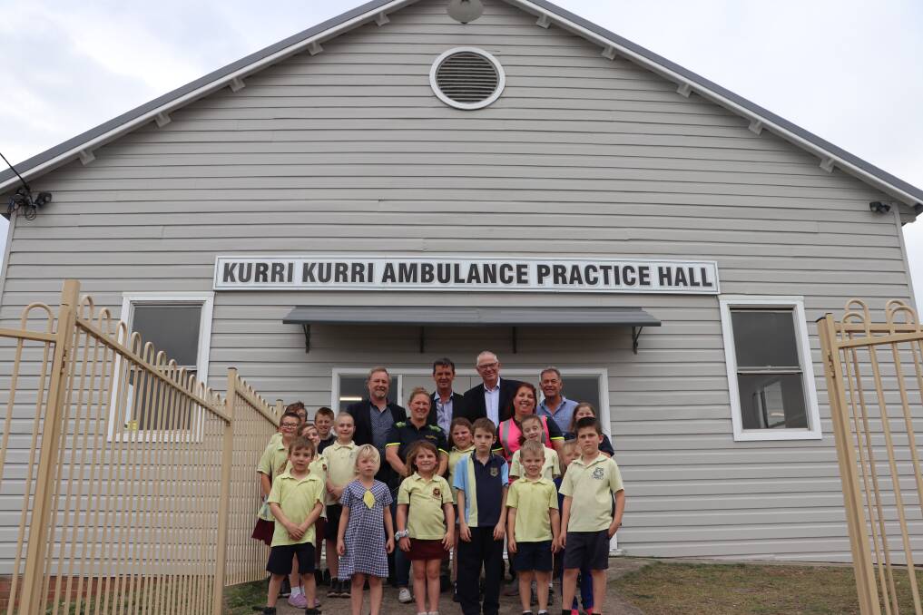 OPEN: Kurri Kurri Community Services CEO Mike Coddington, Cessnock councillor Darrin Gray, Cessnock mayor Bob Pynsent and council's building maintenance coordinator Noel Sweetman with local children at the Kurri Kurri Ambulance Hall, which has reopened after storm damage repairs were completed.