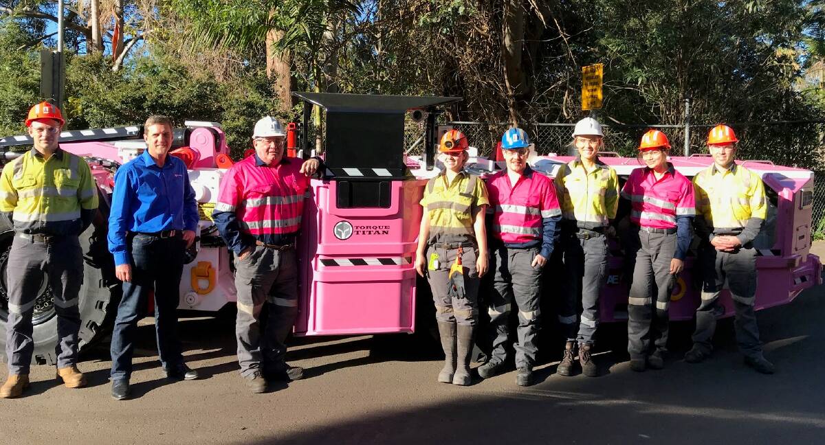 AWARENESS: Staff at South32's Dendrobium Mine site with 'Rizzo', the 10-tonne loader that was painted pink by Alfabs Kurri Kurri to raise awareness for breast cancer.