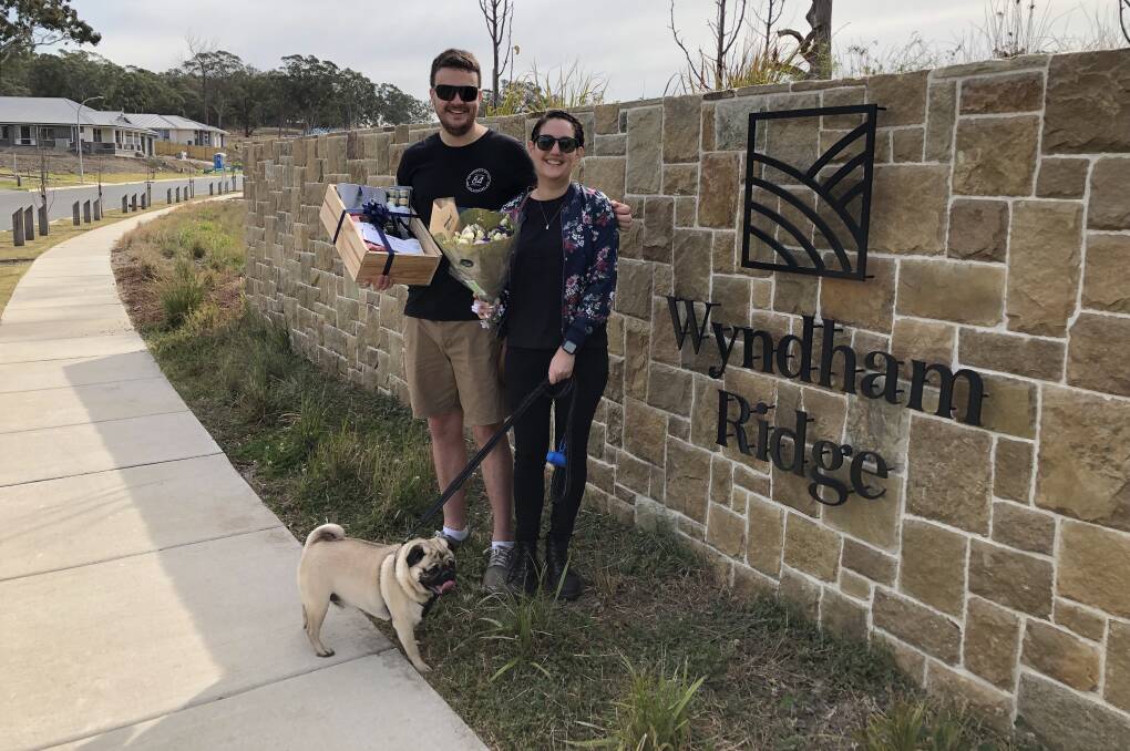 MILESTONE SALE: James Ferguson and Casey Noud, pictured with their dog Hugo, bought the 100th block to be sold at Iris Capital's Wyndham Ridge Estate at Greta.