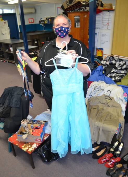 EASING THE BURDEN: Cessnock High School student support officer Stacy Jacobs with some of the formal wear and workwear that has been donated.