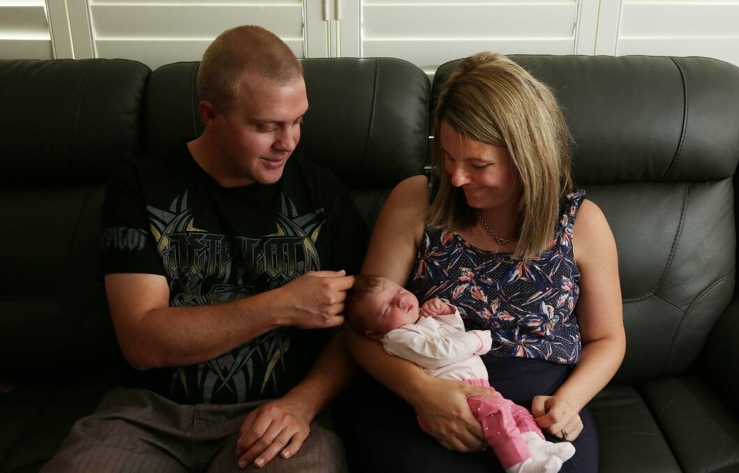 CALM: Jarrad and Aimie Earl with their daughter Ivy, who was born in their car on Old Maitland Road on April 10. Picture: Simone De Peak