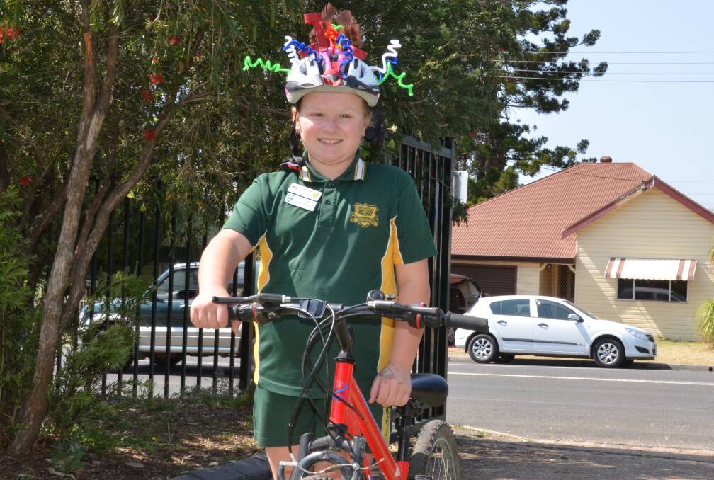 FUN AND PRACTICAL: Cessnock West Public School student Jaimee Ward wearing the 'magpie helmet' she designed as part of a Children's University challenge.