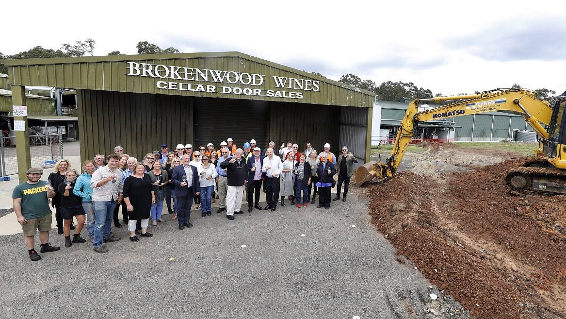 CHEERS: Brokenwood staff, shareholders and guests celebrate the sod turning for the new cellar door on Wednesday. Picture: Chris Elfes