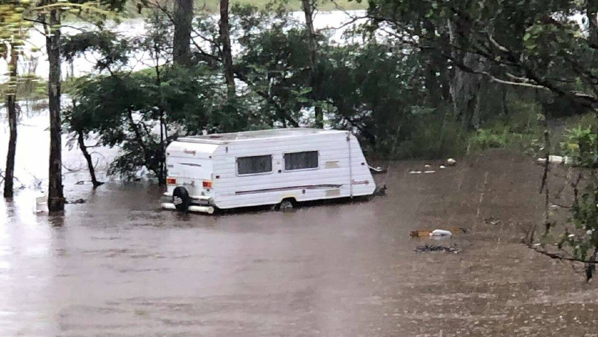 A caravan in flood water at Wollombi Tavern on Saturday. Picture: Cathie Books