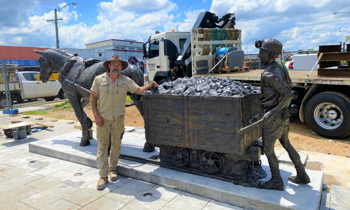 LABOUR OF LOVE: Artist Brett Garling with the pit horse statue after it was installed at Col Brown Rotary Park, Kurri Kurri on Friday. Picture: Jo Dennis/Cessnock City Council