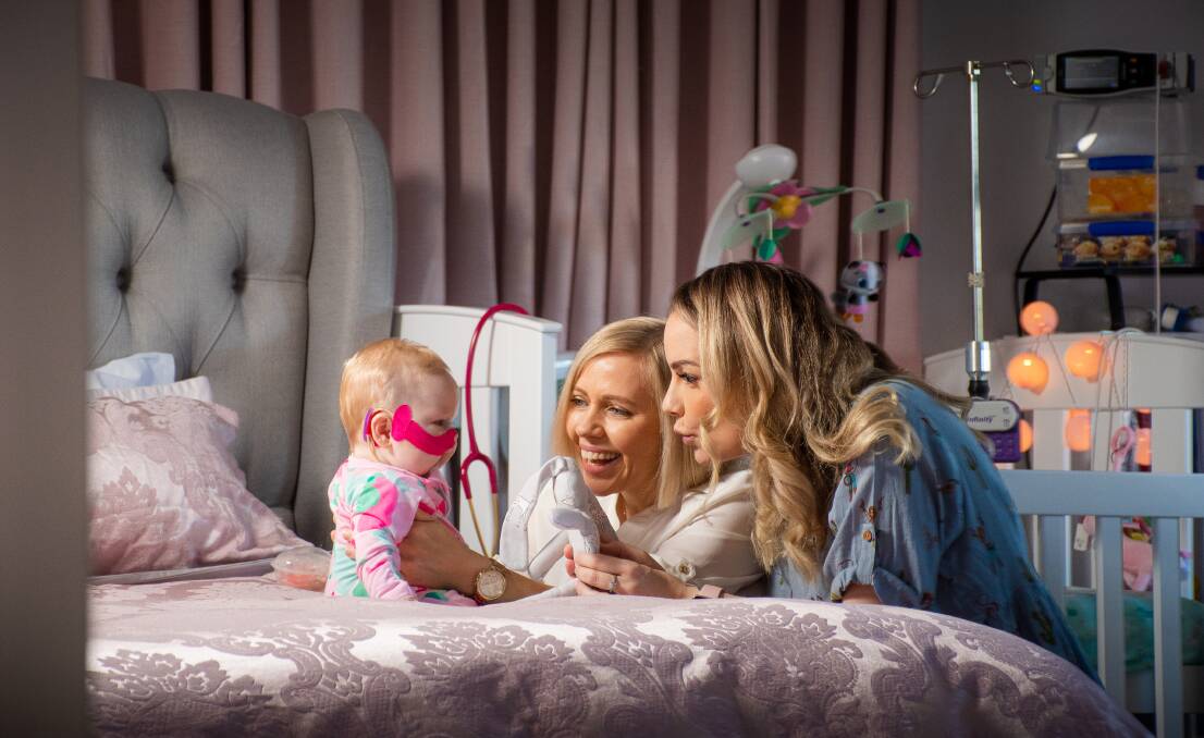 IN LOVE: Tresne and Carly Middleton at home in Broadmeadow with baby Poppy Grace. Picture: Simon McCarthy