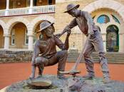 MINT TRIBUTE: A statue outside the Perth Mint to Arthur Bayley (crouching) and William Ford.